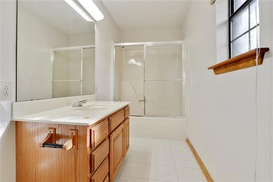Spacious master bath has ceramic tile floors and t
