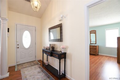 Entryway with natural light and hardwood flooring