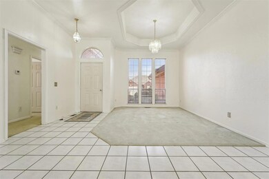 Entrance foyer featuring a notable chandelier, lig
