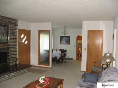 Living room taken from west looking east towards dining area and kitchen doorway.