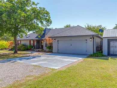 Ranch-style house featuring a garage and a front yard
