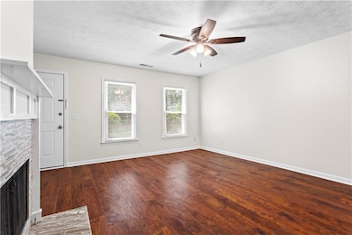 Unfurnished living room featuring a ceiling fan, a
