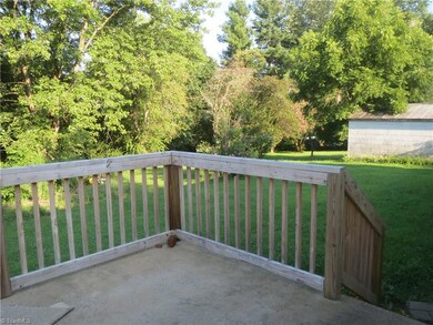 Back deck overlooks wooded yard and is located just off the kitchen making it ideal for grilling out.