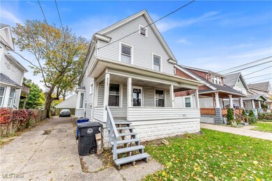 View of front of property with a front yard and covered porch