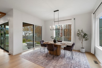 Dining space featuring light wood-type flooring and a chandelier