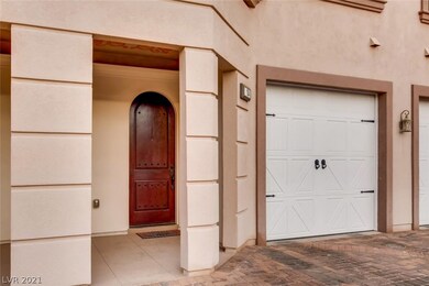 FRONT DOOR OF 104 AND PRIVATE GARAGE IS TO THE RIG