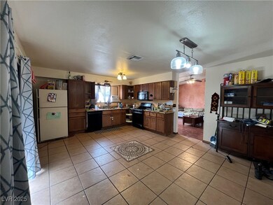 Kitchen featuring light tile patterned floors, a t