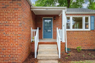 View of exterior entry featuring brick siding