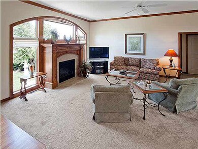 Large, open living room features a gas fireplace a