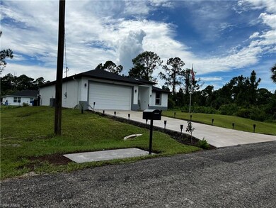View of side of property featuring a garage, drive