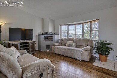 Bright Living Room with Views of Front Deck & Tree