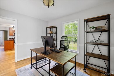Office space with ceiling fan and light hardwood / wood-style floors