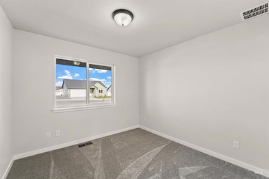 Carpeted empty room with baseboards