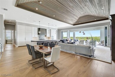 Dining area with ornamental molding, wood ceiling,