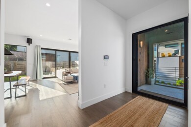 Foyer entrance featuring wood finished floors, ba