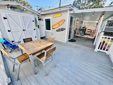 Wooden deck featuring a storage unit
