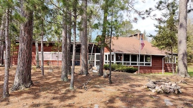 Rear view of property with a sunroom and fence