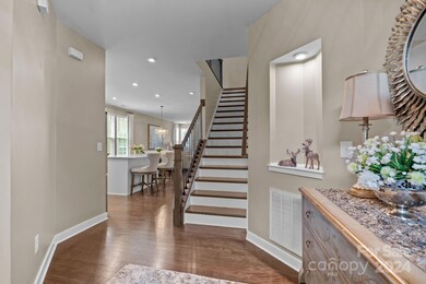 View from entryway into home. Wood flooring throughout main living areas and on stairway.
