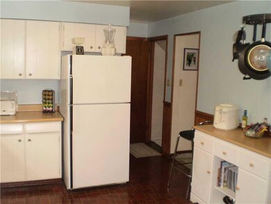 Kitchen. Hallway leads to coat closet and front do