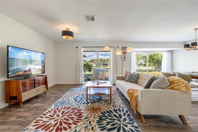 Walk into an open floor plan featuring large pictu