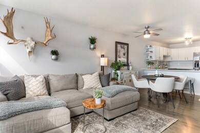 Living room featuring sink, ceiling fan, and light