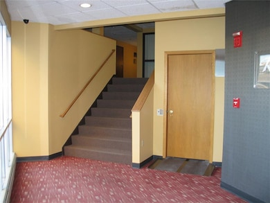 Small Lobby and Stairs From Skywalk Entry.  Door t