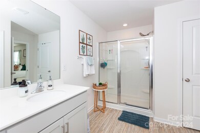 Primary Bathroom with neutral colors and walk in shower with upgraded dual faucets