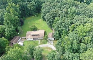 View of property location with a heavily wooded ar