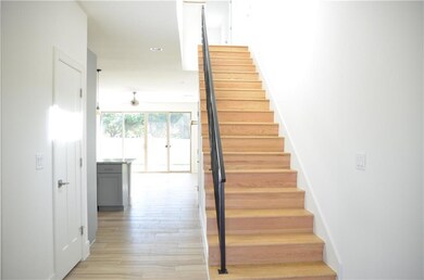 Staircase with wood finished floors and ceiling f