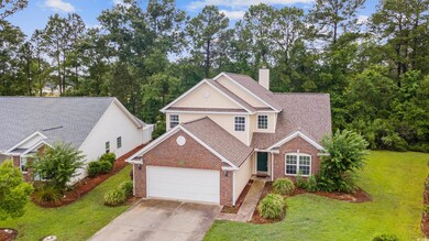 Traditional home with brick siding, an attached garage, a front lawn, a shingled roof, and concrete driveway