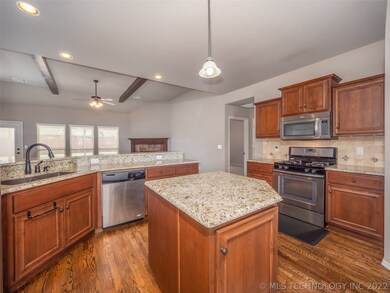 Stainless Steel appliances and gorgeous hardwood f