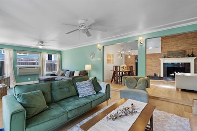 Living room with ceiling fan, wood finished floor