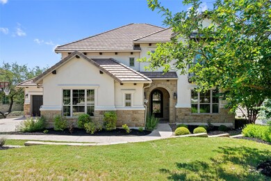 View of front of house featuring stone siding, a 