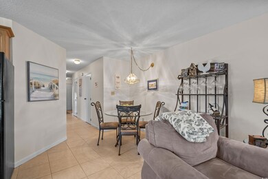 Living room with light tile patterned flooring, a 