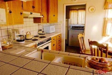 View of kitchen to laundry room at back. Cosy eat-
