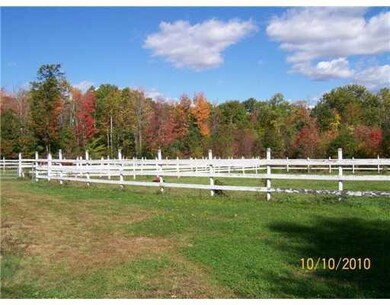 Land. Two fenced pastures with board...