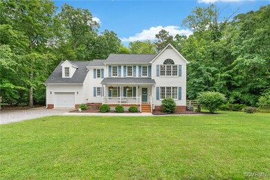 Colonial home featuring a porch, a shingled roof,