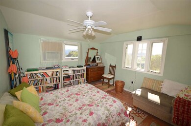 upstairs bedroom with mountain views and breeze
