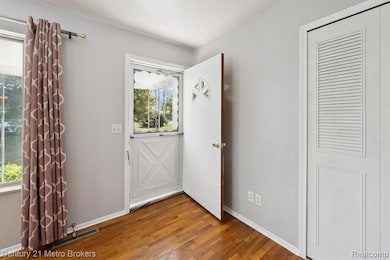 Foyer featuring wood finished floors and baseboards