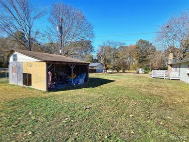 View of yard with an outdoor structure and a deck