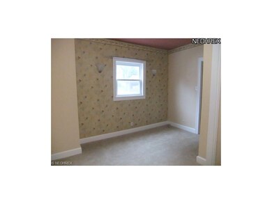 The dining room leads to the first floor den with 