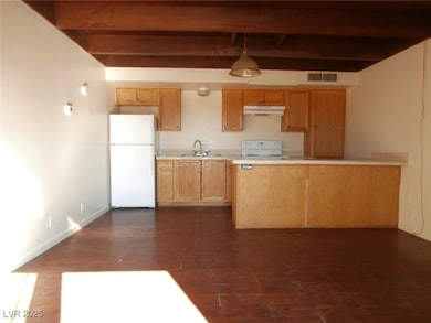 Kitchen featuring freestanding refrigerator, beam