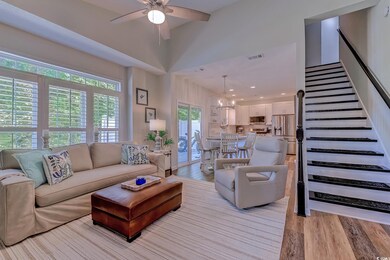 Living room with visible vents, light wood-style f