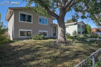 Rear view of house with a yard