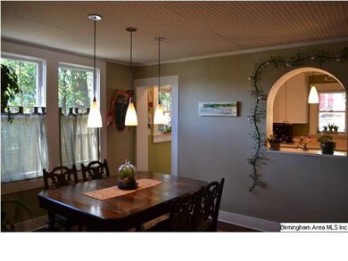 Dining room with arched opening to kitchen.