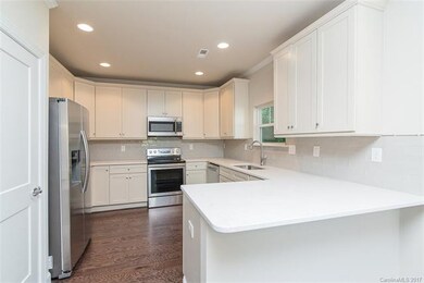 This beautiful kitchen features granite counter-to