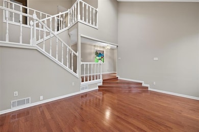 Living room at front of home with view of dining room wall