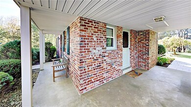 Wrap-around covered porch with side access from fa