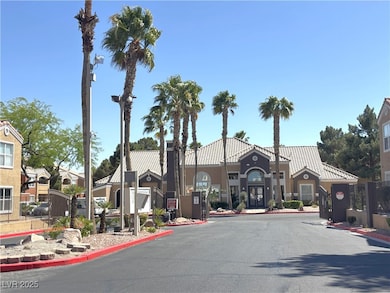 View of road with a gated entry, curbs, and street