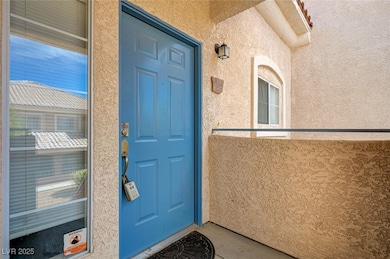 Doorway to property featuring stucco siding